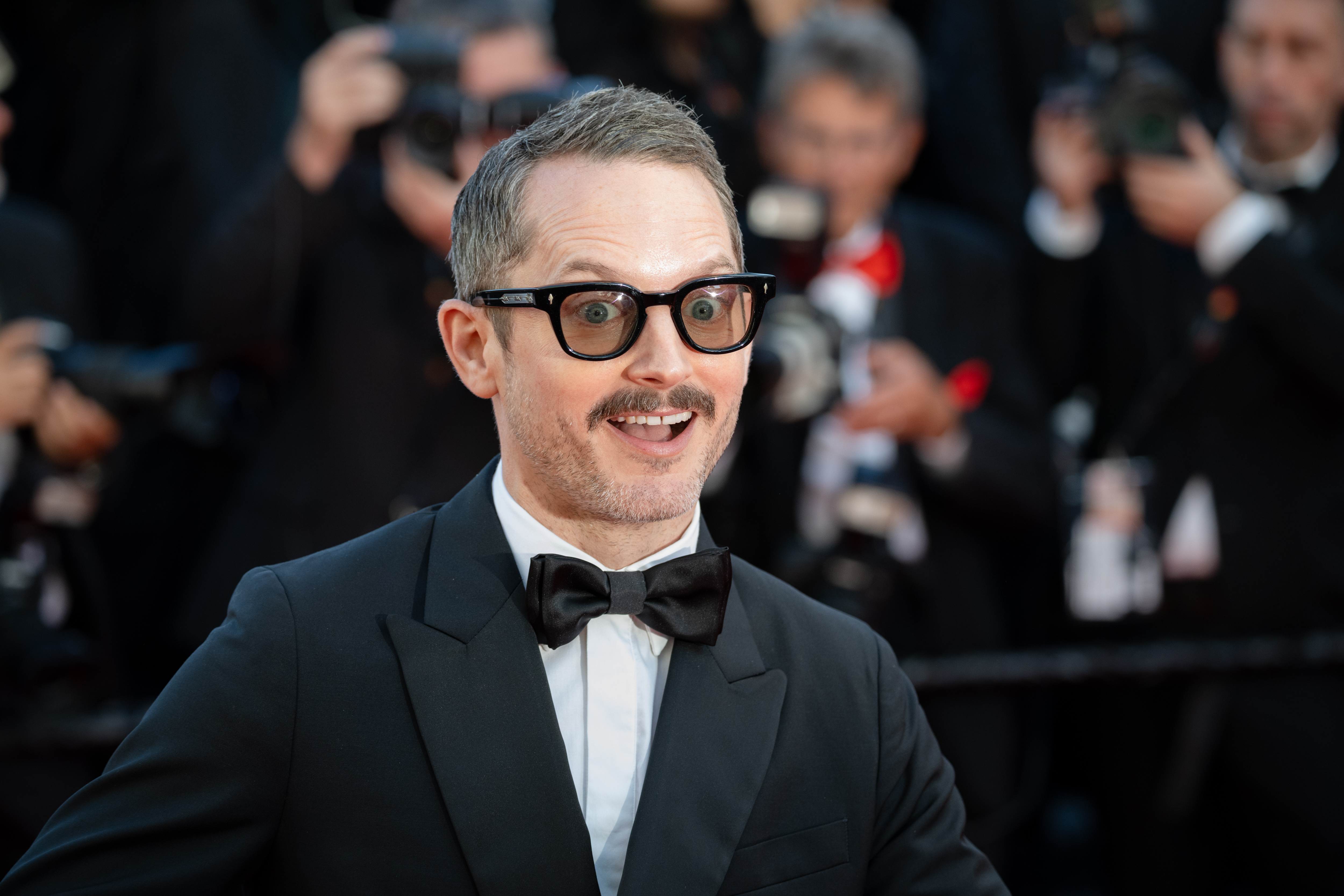 Image Description: Elijah Wood attends the opening ceremony red carpet of the movie La Venus Electrique during the 79th Cannes Film Festival Cannes France 2026-05-12