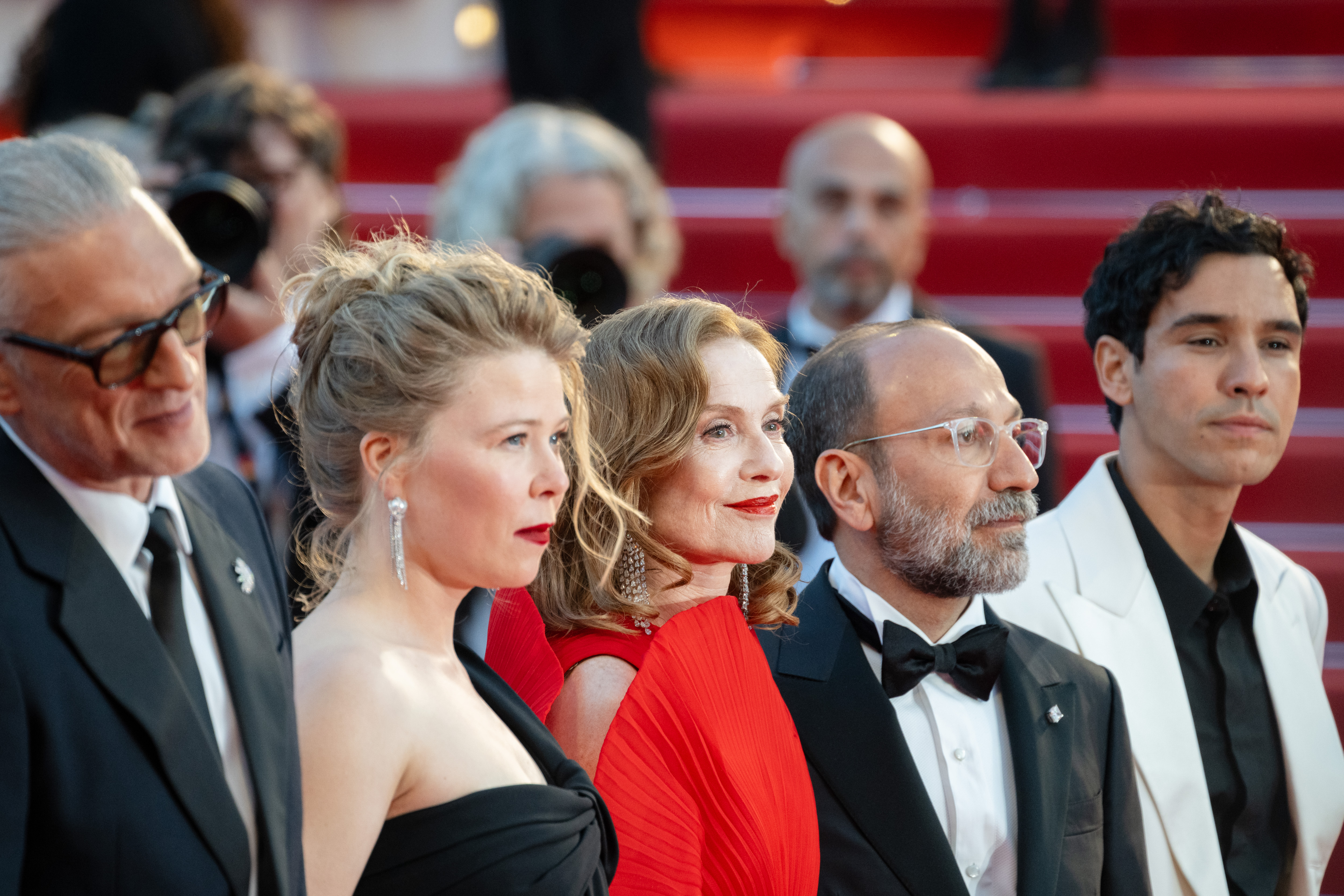 Image Description: Vincent Cassel India Hair Isabelle Huppert Asghar Farhadi and Adam Bessa attend the competition screening red carpet of the movie Histoires Paralleles during the 79th Cannes Film Festival Cannes France 2026-05-14