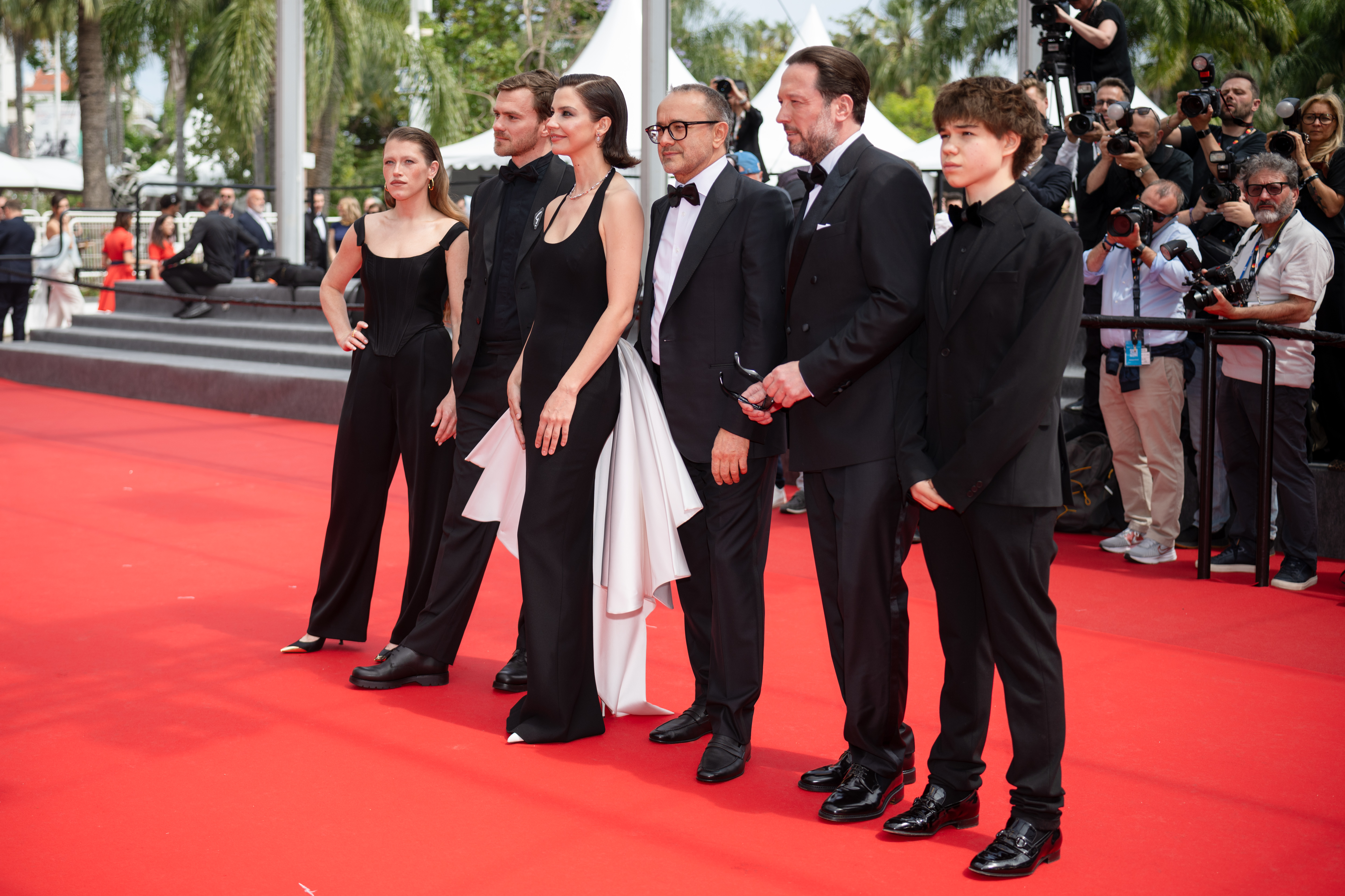 Image Description: Varvara Shmykova Yuriy Zavalnyouk Iris Lebedeva Andrey Zvyagintsev Dmitriy Mazurov and Boris Kudrin attend the competition screening red carpet of the movie Minotaur during the 79th Cannes Film Festival Cannes France 2026-05-19