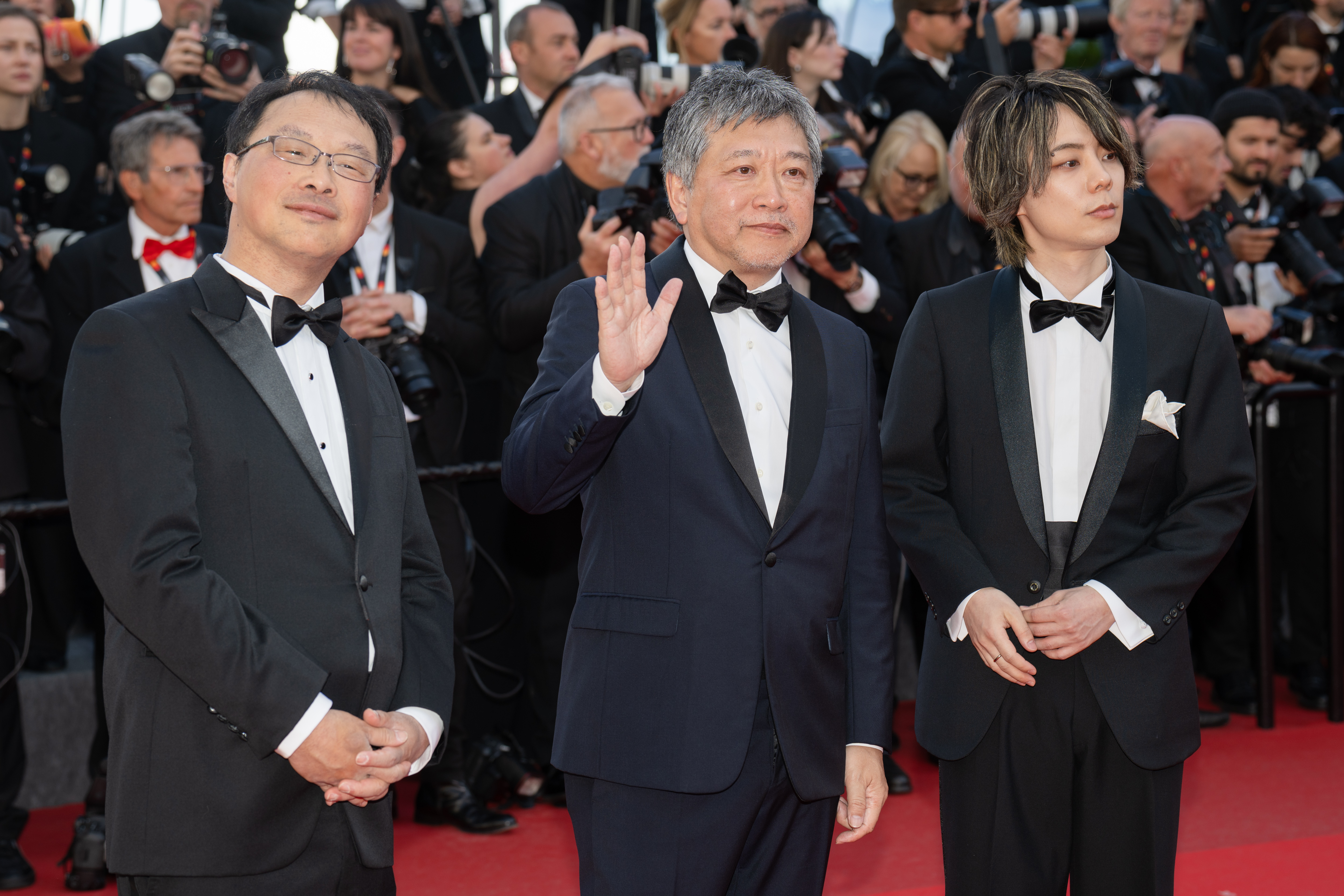 Image Description: Koji Fukada Hirokazu Kore-eda and a guest attend the special screening red carpet of the movie Karma during the 79th Cannes Film Festival Cannes France 2026-05-15