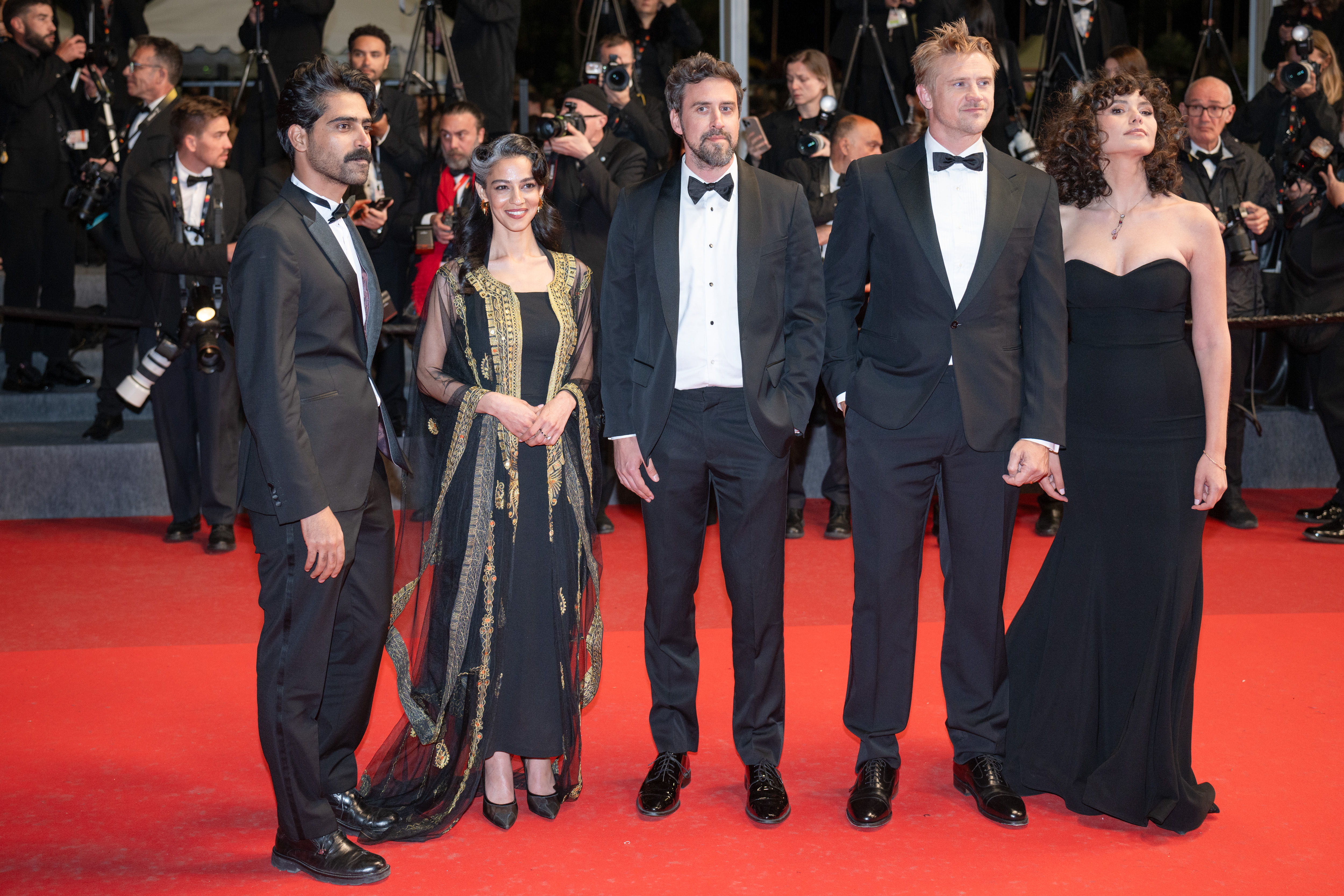 Image Description: Guests Reed Van Dyk Boyd Holbrook and Gratiela Brancusi attend the competition screening red carpet of the movie Gentle Monster during the 79th Cannes Film Festival Cannes France 2026-05-15