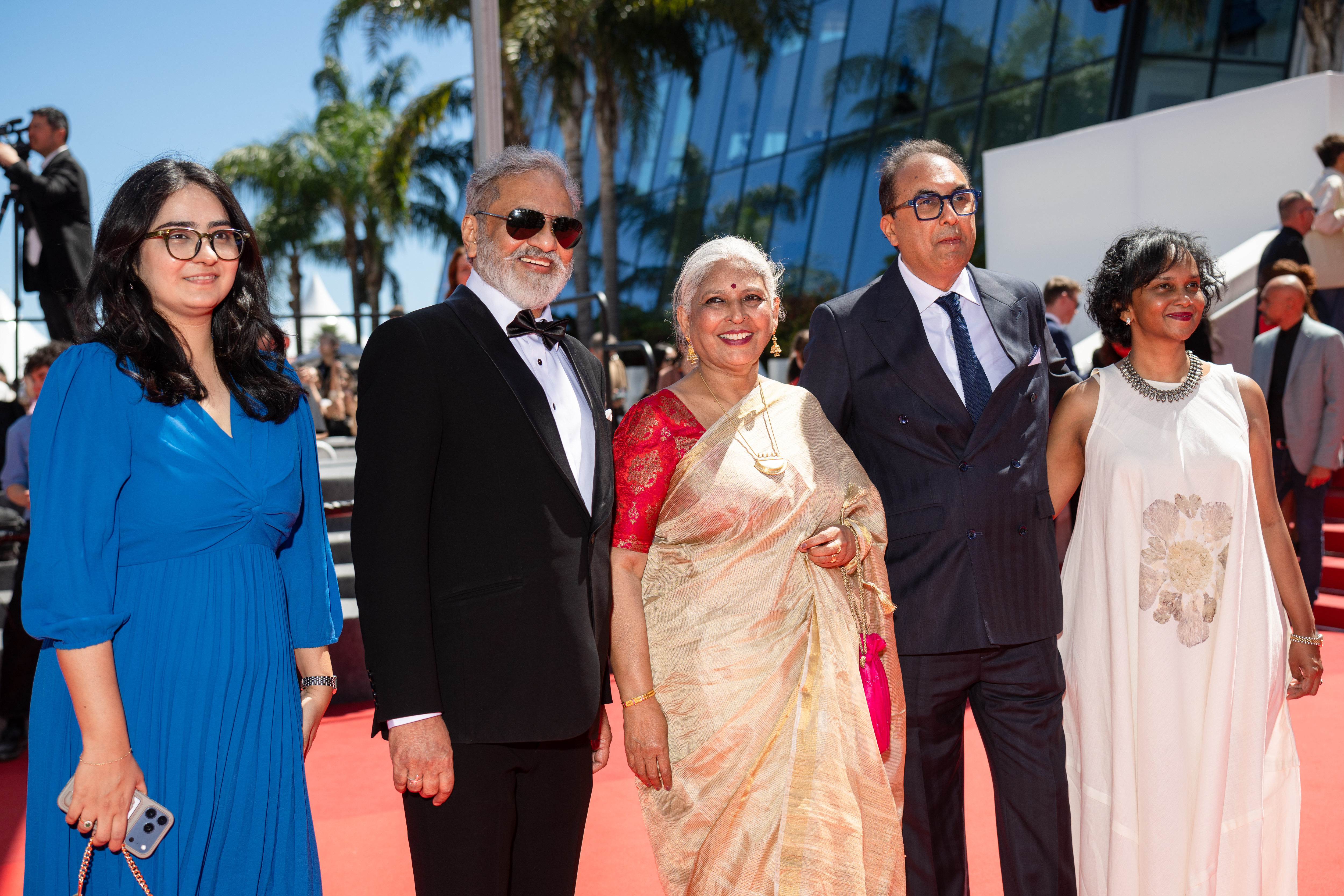 Image Description: A guest Joy Mathew a guest Jury Member Shivendra Singh Dungarpur and Teesha Cherian attend the competition screening red carpet of the movie Sheep in the Box during the 79th Cannes Film Festival Cannes France 2026-05-16