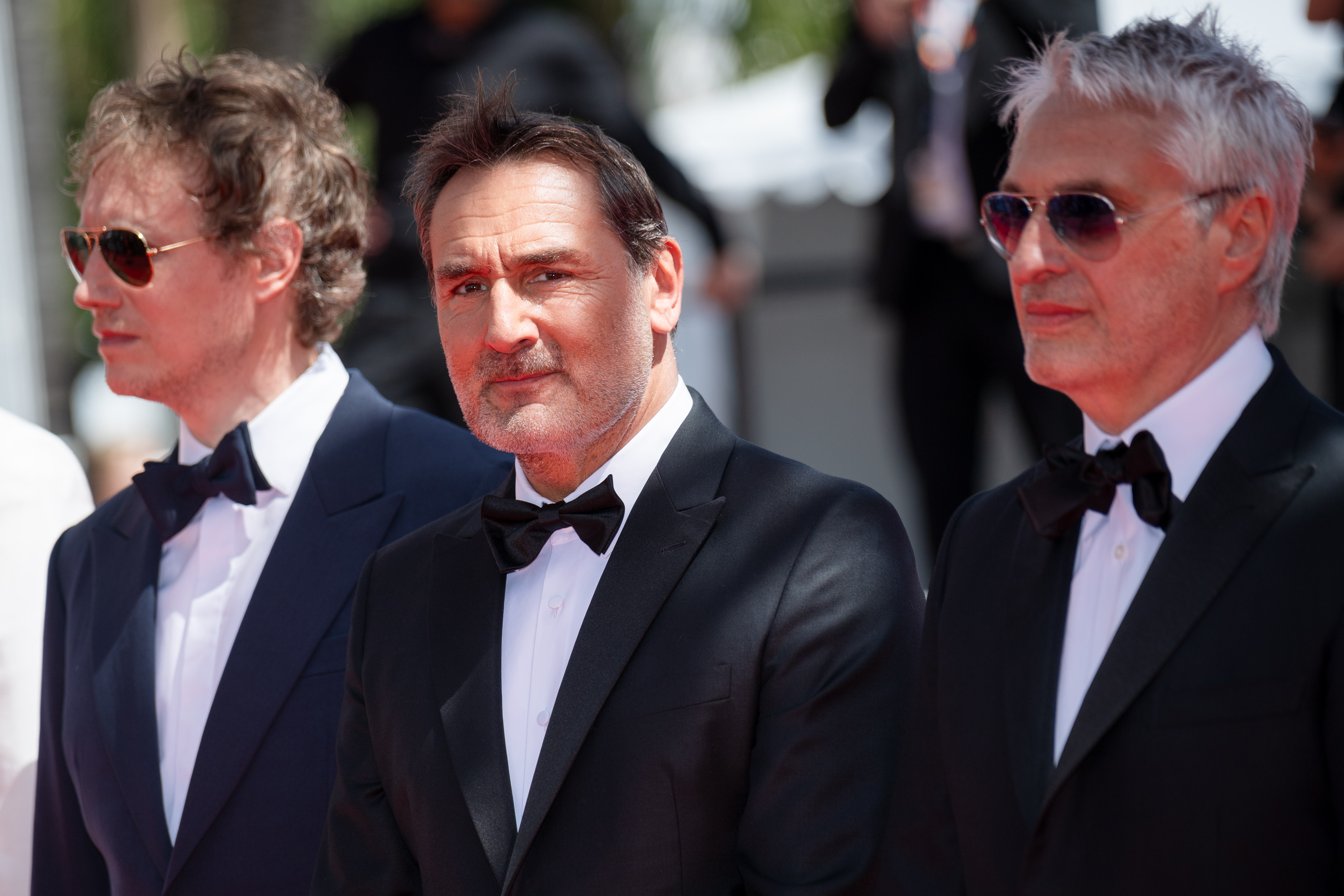 Image Description: Laszlo Nemes Gilles Lellouche and Alain Goldman attend the competition screening red carpet of the movie Moulin during the 79th Cannes Film Festival Cannes France 2026-05-17