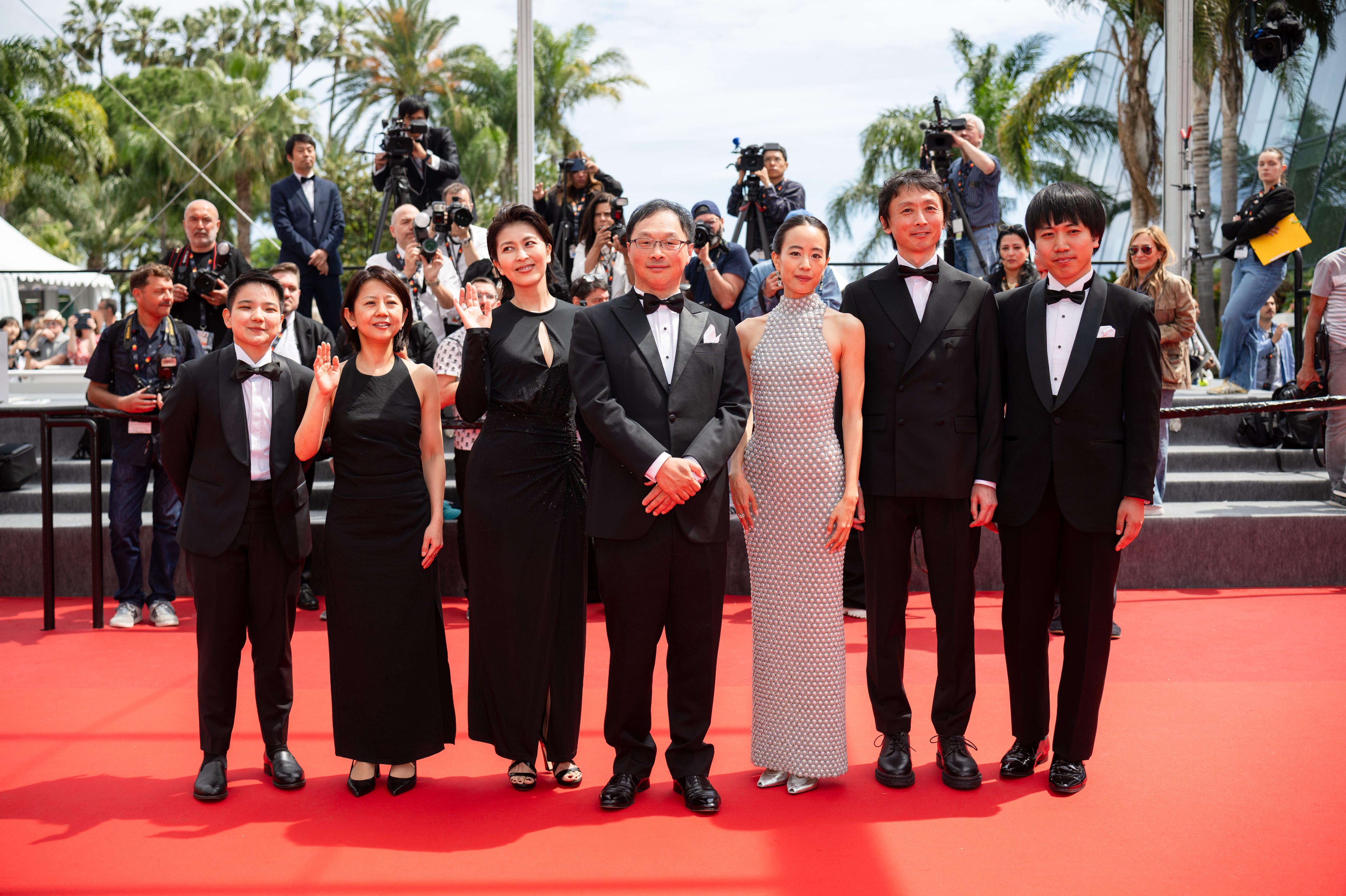 Image Description: Tan Si En a guest Takako Matsu Koji Fukada Shizuka Ishibaschi Terutaro Osanai and a guest attend the competition screening red carpet of the movie Nagi Notes during the 79th Cannes Film Festival Cannes France 2026-05-13