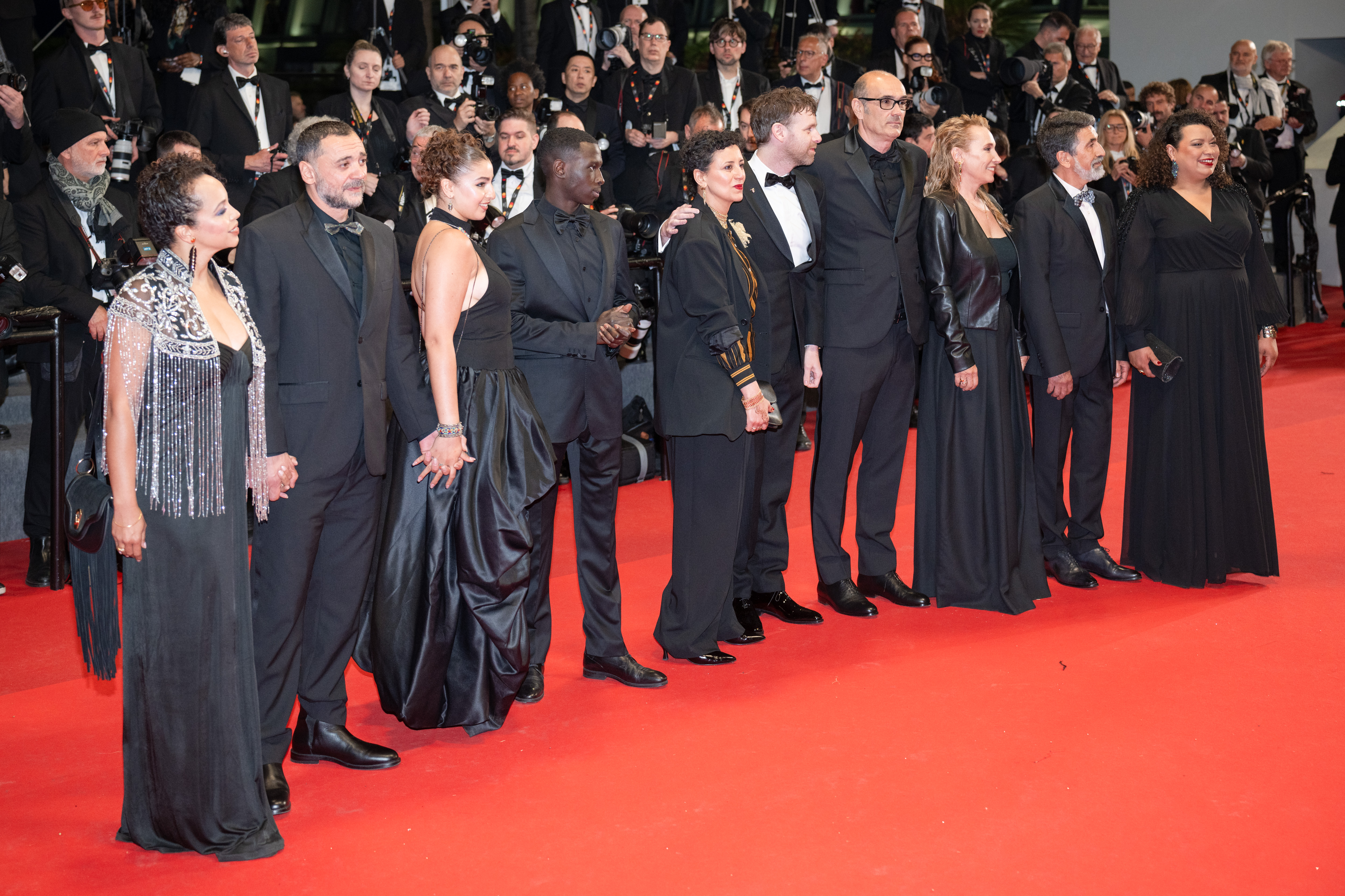 Image Description: Sandy Lewis Godefroy Nedjim Bouizzoul Emma Boumali Diamadoua Sissoko Mounira Barbouch Antoine Reinartz Vincent Garenq Emmanuelle Bercot Azize Kabouche and Guest attend the special screening red carpet of the movie L Abandon during the 79th Cannes Film Fest