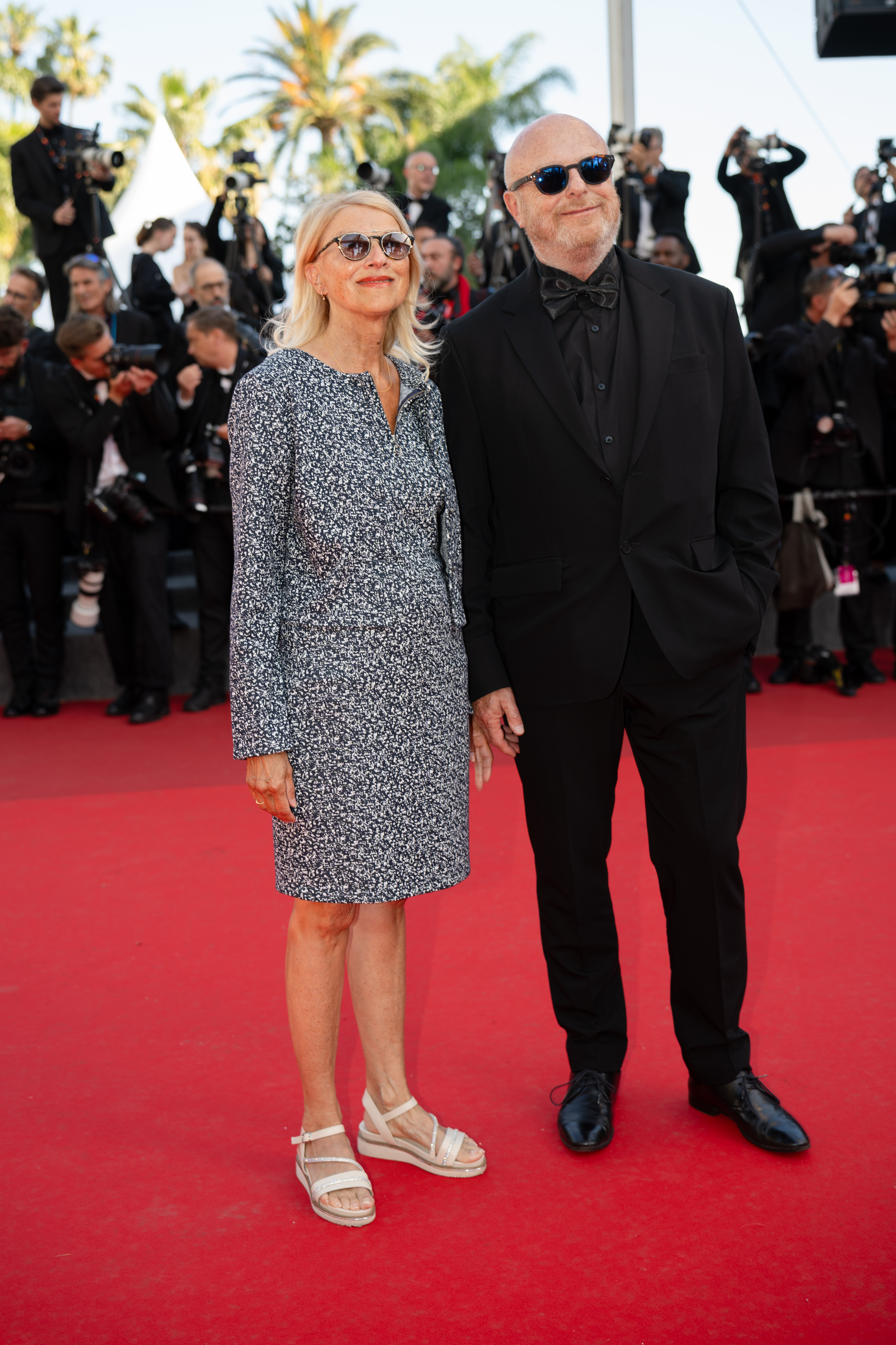 Image Description: Gerard Krawczyk - L - and a guest attend the competition screening red carpet of the movie Histoires de la Nuit during the 79th Cannes Film Festival Cannes France 2026-05-22