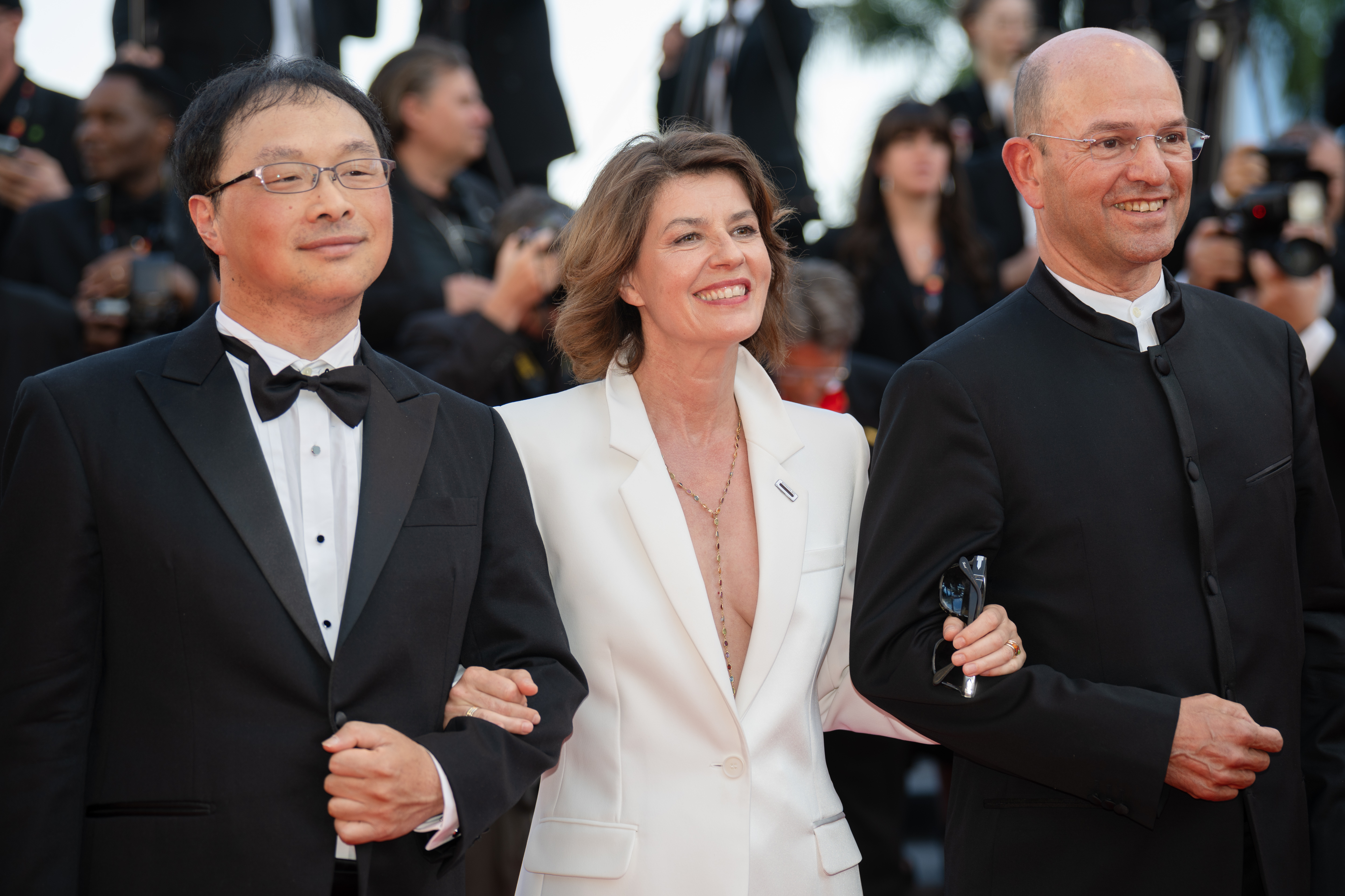 Image Description: Koji Fukada Irene Jacob and a guest attend the competition screening red carpet of the movie Histoires de la Nuit during the 79th Cannes Film Festival Cannes France 2026-05-22