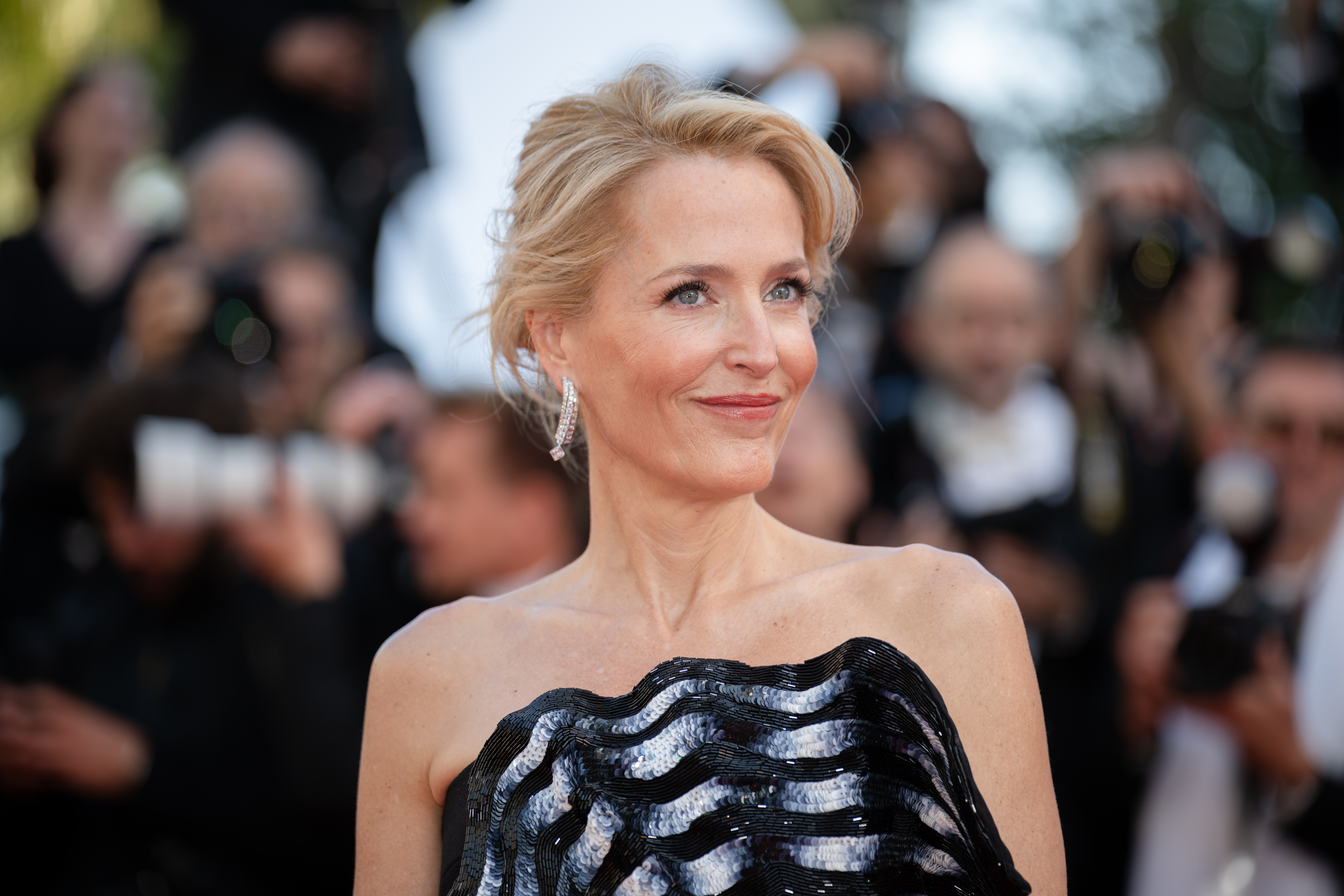 Image Description: Gillian Anderson attends the competition screening red carpet of the movie Histoires de la Nuit during the 79th Cannes Film Festival Cannes France 2026-05-22