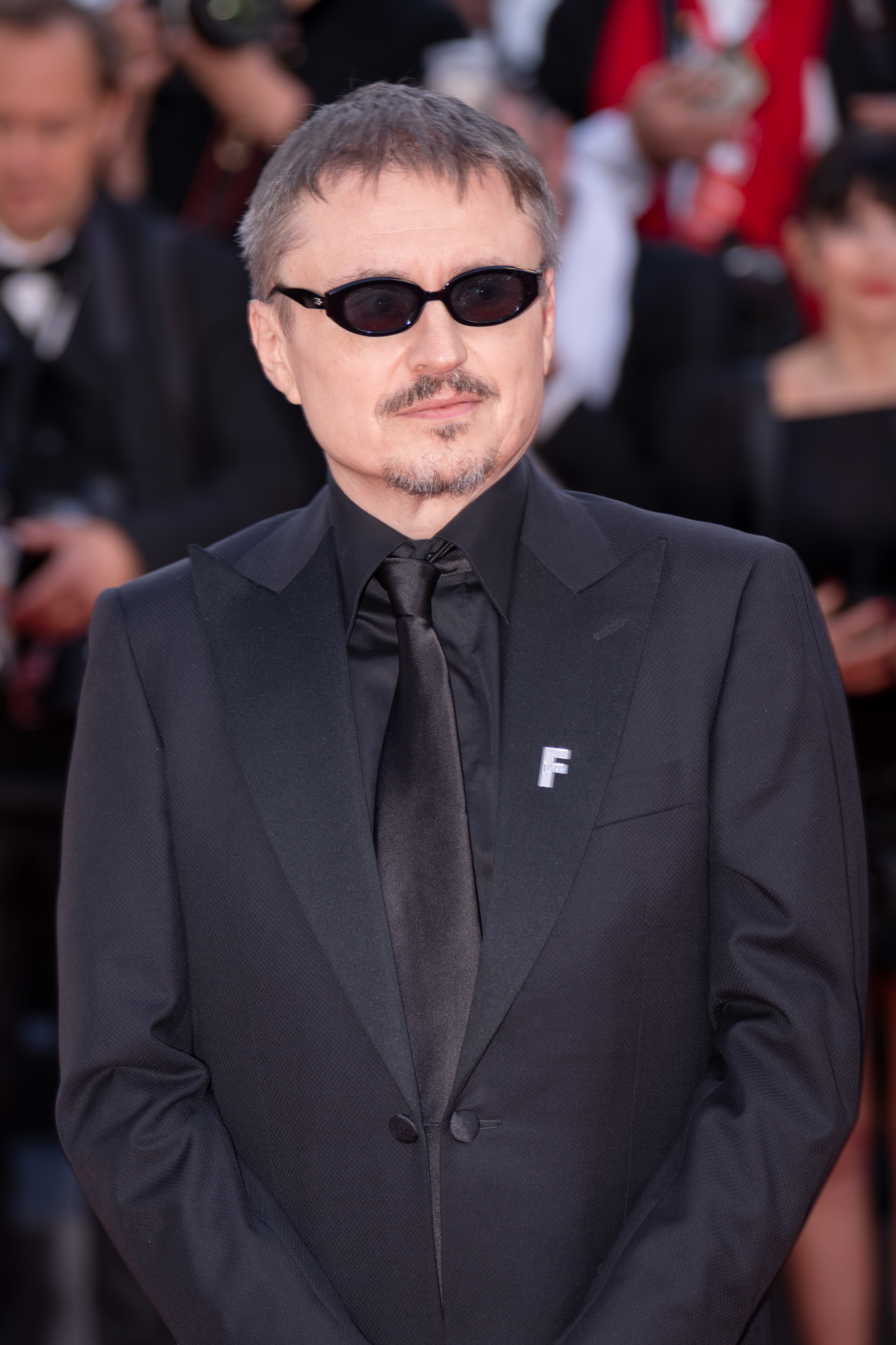 Fjord Director Cristian Mungiu stands on the red carpet for Fjord