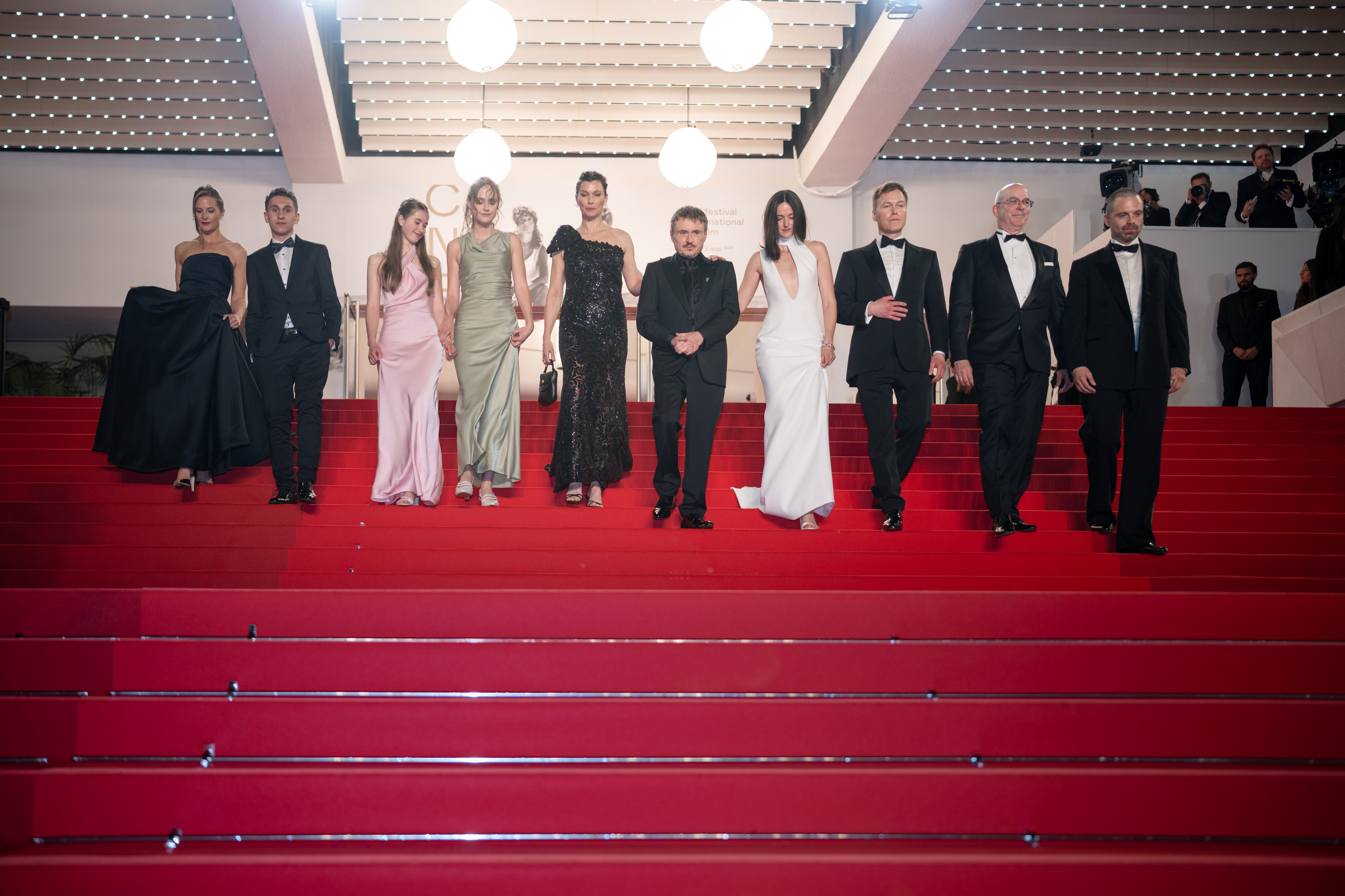 The cast and crew of Fjord walk down the steps of the red carpet at the Cannes Film Festival